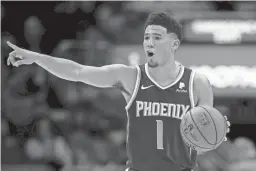  ??  ?? Suns guard Devin Booker calls a play in the second half against the New Orleans Pelicans at the Smoothie King Center on Saturday in New Orleans.