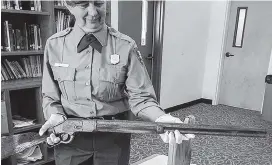 ?? National Park Service via AP ?? Park archaeolog­ist Eva Jensen holds the 1882 Winchester rifle she found leaning against a tree in Great Basin National Park in 2014 near Baker, Nevada. A new exhibit featuring the ‘Forgotten Winchester’ has opened at the park’s visitor center near the Nevada-Utah line.