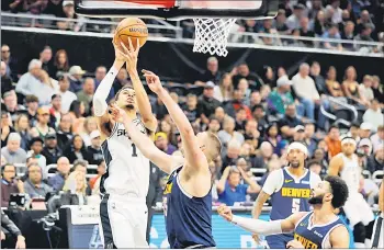  ?? — AFP photo ?? Wembanyama shoots over Jokic in the first half at Moody Centre in Austin, Texas.
