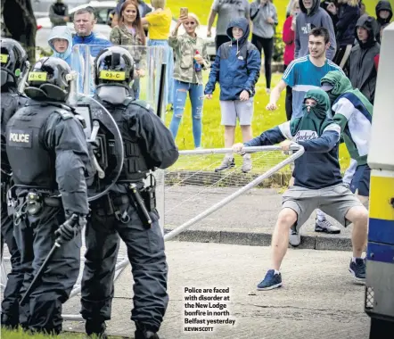  ?? KEVIN SCOTT ?? Police are faced with disorder at the New Lodge bonfire in north Belfast yesterday