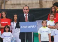  ?? RAAD ADAYLEH / ASSOCIATED PRESS ?? Prince Ali bin al-Hussein of Jordan, flanked by young soccer players, speaks during an event in Amman on Wednesday.