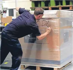  ??  ?? A Bonar Yarns technician parcels up a pallet for delivery.