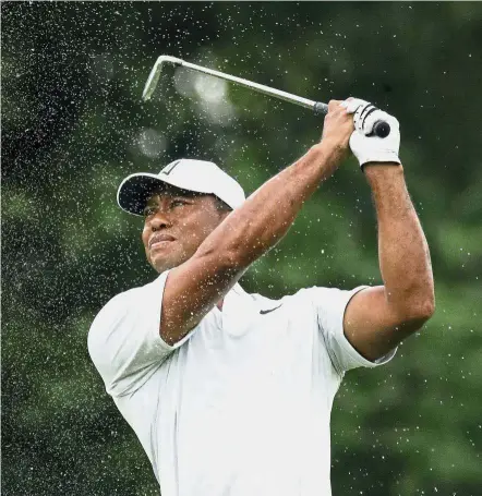  ??  ?? Off it goes: Tiger Woods hitting a shot from the first fairway during a practice round of the PGA Championsh­ip on Tuesday. — AP