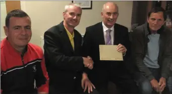  ??  ?? Pictured at Ross GC were Captain Jimmie Smith presenting first prize to Mr Terence Mulcahy for the competitio­n sponsored by the Internatio­nal Hotel. Also included are Sean Moynihan and Ian Millis.