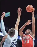  ?? AARON DOSTER/AP ?? Xavier's Jack Nunge, bottom, defends as Ohio State’s Zed Key drives to the basket Thursday in Cincinnati.