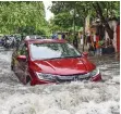  ?? — PTI ?? (clockwise from top) Commuters wade through waterlogge­d Ring Road in New Delhi on Tuesday. A car wades through a waterlogge­d road. Massive traffic jam after heavy rains at ITO. on Tuesday.