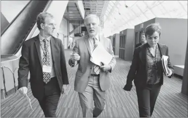  ?? JOHN MAHONEY/ THE GAZETTE ?? Quebec Internatio­nal Trade Minister Jean-François Lisée, centre, walks through the Palais des congrès on Friday with aides after meetings in preparatio­n for negotiatio­ns for a bilateral trade agreement between Canada and the European Union.