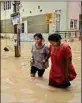  ?? ?? Residents wade through a waterlogge­d street after heavy overnight rain, at the Horamavu area in Bengaluru, on Wednesdayp­ti