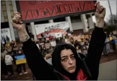  ?? AP PHOTO/ENRIC MARTI ?? A woman holds a sign during a protest in Kyiv, Ukraine, Sunday March 24, 2024, to demand the freedom of Ukrainian Mariupol’s Azovstal defenders still being held prisoners by Russia.