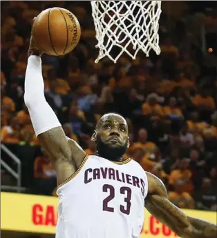  ?? TNS ?? Cavs’ LeBron James goes up to dunk against the Toronto Raptors on Wednesday in Cleveland. James had 39 points.