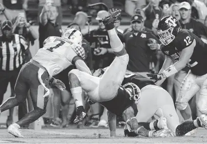  ?? Michael Wyke / Associated Press ?? A&amp;M running back Trayveon Williams dives into the end zone for the six points in OT that sealed the win over No. 13 Kentucky.