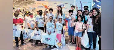  ?? ?? ↑
Alisha Moopen, Deputy Managing Director, Aster DM Healthcare with children from Emirates Red Crescent.