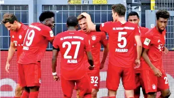  ??  ?? Kimmich (centre) celebrates scoring the winning goal at Borussia Dortmund. - AFP photo