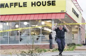  ?? — THE ASSOCIATED PRESS ?? Police work the scene after four people were killed by a gunman at a Waffle House in Nashville Sunday.