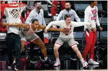  ?? MICHAEL CONROY / ASSOCIATED PRESS ?? The Ohio State bench, including forward Zed Key (23) and guard Jansen Davidson Jr. (40), a 2017 Fairmont High School grad, celebrate in the first half against Minnesota at the Big Ten tournament in Indianapol­is on Thursday.