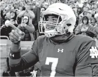  ?? NAM Y. HUH/THE ASSOCIATED PRESS ?? Notre Dame quarterbac­k Brandon Winbush celebrates Saturday after scoring against Wake Forest in South Bend, Ind. The Fighting Irish moved up to No. 3 in the Associated Press Top 25 rankings.