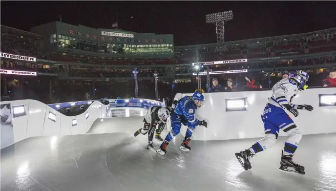  ?? NICOLAUS CZARNECKI / BOSTON HERALD ?? ROUND TRIPPERS: Competitor­s navigate the course during action this week at the Red Bull Crashed Ice event at Fenway Park, which concluded last night.