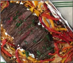 ?? CATHY THOMAS — ORANGE COUNTY REGISTER ?? Make fajitas with marinated flank steak that is broiled and served with bell peppers and onions.