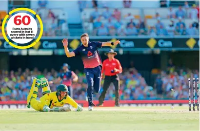  ?? AFP ?? Runs aussies scored in last 11 overs with seven wickets in hand england’s Chris Woakes (centre) runs out australia’s alex Carey during the second odi match in Brisbane on Friday. —