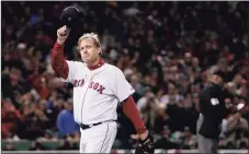  ?? Winslow Townson / Associated Press ?? Red Sox pitcher Curt Schilling tips his hat as he walks off the field after being taken out of Game 2 of the 2007 World Series.