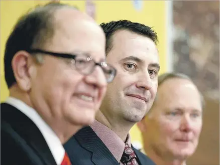  ?? Luis Sinco Los Angeles Times ?? USC PRESIDENT C.L. Max Nikias, left, and then-USC Athletic Director Pat Haden, right, introduce Steve Sarkisian as the new Trojan football coach in December 2013. Sarkisian was fired two years later after a Times report on his alcohol use in his...