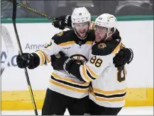  ?? TONY GUTIERREZ — THE ASSOCIATED PRESS ?? Boston's Pavel Zacha, left, and David Pastrnak celebrate after Zacha scored the tying goal in the third period against the Stars at Dallas.