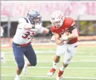  ?? Krista Benson / For Hearst Connecticu­t Media ?? Sacred Heart quarterbac­k Kevin Duke, right, looks to avoid a tackle from Robert Morris’ Adam Wollet on Saturday in Fairfield.