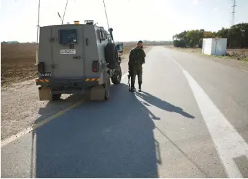  ?? (Reuters) ?? AN ISRAELI soldier stands on a road near Gaza.