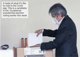  ??  ?? A taste of what it’s like to vote in the Covid age. This is a candidate in the Ecuadorian presidenti­al election voting earlier this week