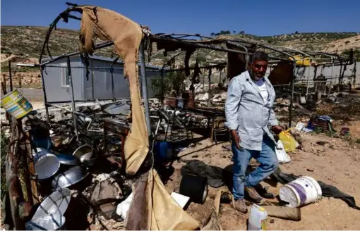  ?? JAAFAR ASHTIYEH/AFP VIA GETTY IMAGES ?? A Palestinia­n inspected the damage to his belongings on Saturday in the village of al-Mughayyir near Ramallah.