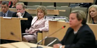  ?? STUART CAHILL PHOTOS / HERALD STAFF ?? COMMUNICAT­ION GAP: Transporta­tion Secretary Stephanie Pollack watches as the former head of the state’s Registry of Motor Vehicles Erin Deveney, also seen opposite page, speaks at a legislativ­e oversight hearing on Wednesday. RMV headquarte­rs, below, is seen in Quincy.