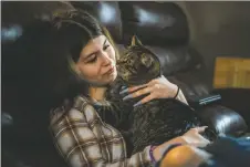  ?? ?? Adora Lopez, 14, is comforted by her cat Ben in her home on Monday (March 7) in El Prado. Adora, who suffers from an undiagnose­d illness that saw her hospitaliz­ed for weeks in Albuquerqu­e late last year, has seen her and her families life uprooted as they navigate the mental, emotional, physical, and financial stress of her mysterious illness.