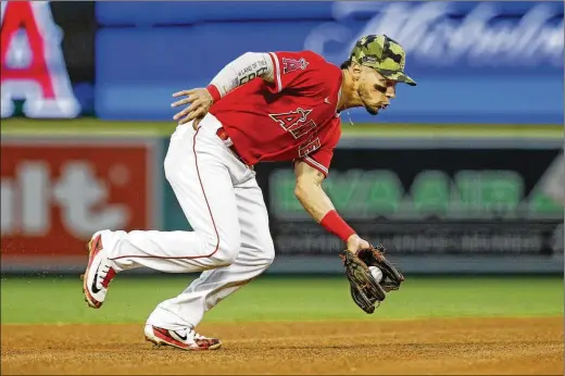  ?? GARY CORONADO/LOS ANGELES TIMES/TNS ?? Though he has bounced around in the big leagues, Angels shortstop Andrew Velazquez has settled in nicely with the L.A. team. It’s quite a step up from his teenage years of fielding bad-hop grounders on a patchwork grass field covered in rocks and practicing on a concrete softball field.