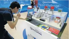  ?? /Reuters ?? A digital innovator: A man visits Qualcomm's booth at the Global Mobile Internet Conference in Beijing in April.