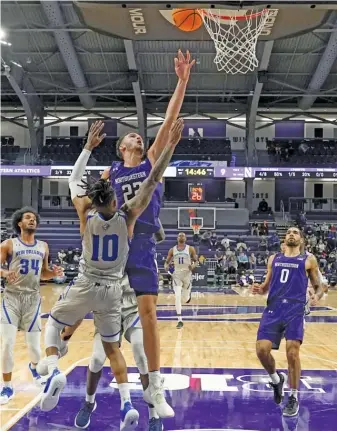  ?? CHARLES REX ARBOGAST/AP ?? Pete Nance, scoring over New Orleans’ Derek St. Hilaire, led three Northweste­rn players in double figures with 18 points Tuesday night at Welsh-Ryan Arena in Evanston.