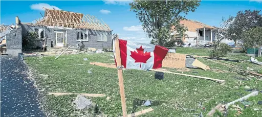  ?? JUSTIN TANG THE CANADIAN PRESS ?? The aftermath of a tornado near Ottawa last month. A new report urges world leaders to ramp up efforts to fight climate change or face more extreme weather.