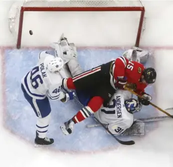  ?? CHASE AGNELLO-DEAN/GETTY IMAGES ?? Blackhawk Artem Anisimov was on top of Leafs netminder Frederik Andersen when Nick Schmaltz scored Wednesday night in Chicago. The line between good goal and no goal has been blurred beyond recognitio­n.