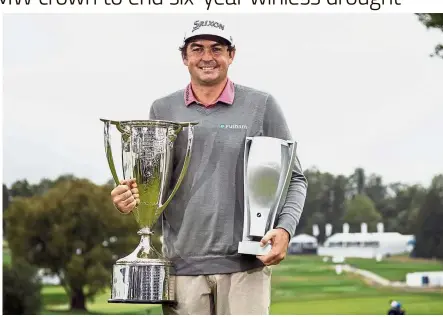  ??  ?? At long last: Keegan Bradley poses with his trophies after winning the BMW Championsh­ip at the Aronimink Golf Club on Monday. Bradley held off Justin Rose in a sudden-death playoff to win the rain-plagued golf tournament for his first PGA Tour victory in six years. — AP