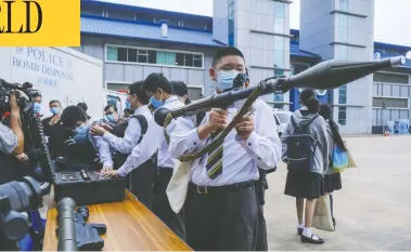  ?? PAUL YEUNG/BLOOMBERG ORG ?? A student holds up a rocket launcher during “National Security Education Day” in Hong Kong on Thursday.