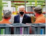  ?? AP ?? President Joe Biden visits with volunteers at the Houston Food Bank on Friday in Houston as part of his trip to survey damage caused by severe weather in Texas.