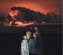  ?? GREGORY BULL/AP ?? While the Mauna Loa volcano makes fora great photo opportunit­y, slow-moving lava could eventually reach a key highway on Hawaii’s Big Island.