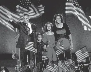  ?? TANNEN MAURY/ EPA ?? President- elect Barack Obama with his daughters Sasha, second from left; and Malia, second from right; and his wife, Michelle, wave after his address at Grant Park in Chicago to celebrate his victory on Election Day 2008.