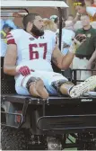  ?? Apphoto ?? HURTING: BC tackle Aaron Monteiro is carted off the field during the Eagles’ loss on Saturday.