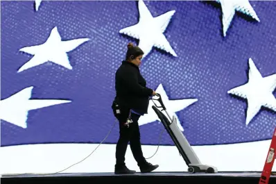  ?? Associated Press ?? ■ A worker vacuums the stage Friday before the Iowa Democratic Party's Liberty and Justice Celebratio­n begins in Des Moines, Iowa.