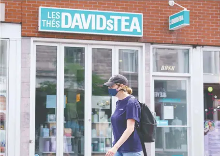  ?? PAUL CHIASSON/THE CANADIAN PRESS ?? A woman walks past a closed Davidstea store in Montreal on Wednesday. The tea merchant said it would “significan­tly” reduce its brick-and-mortar footprint while accelerati­ng a transition to online retailing and wholesale distributi­on in North America.