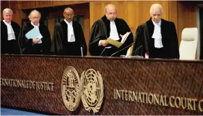  ??  ?? THE HAGUE, NETHERLAND­S: Judges, with presiding judge Ronny Abraham of France, second right, re-enter the World Court yesterday. — AP