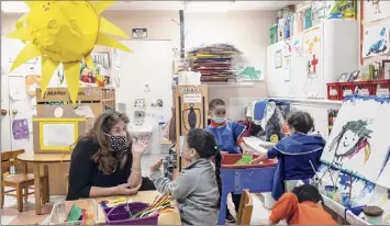  ?? Kirsten Luce / New York Times ?? Maria Collier, who runs the Cypress Hills care center, in a classroom with Emily Ovalles, 5, at the facility in Brooklyn on March 10. Child care centers have emerged as substitute schools.