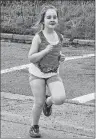  ?? NANCY KING/CAPE BRETON POST ?? Clara Beth Andrews, in her first year as a member of the Kids’ Run Club at Robin Foote Elementary in Westmount, makes her way back to the school after taking part in a run on Friday.