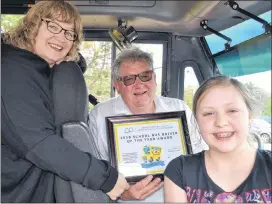  ?? ERIC MCCARTHY/JOURNAL PIONEER ?? Donna MacLeod, left, secretary of the P.E.I. Home and School Federation, and Ellerslie Elementary School Grade 6 student, Cierra Gallant, congratula­tes Myles Noye on being chosen the federation’s 2018 School Bus Driver of the Year