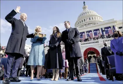  ?? AP photo ?? Joe Biden is sworn in as the 46th president of the United States by Chief Justice John Roberts as Jill Biden holds the Bible during the 59th Presidenti­al Inaugurati­on at the U.S. Capitol in Washington on Wednesday as their children Ashley and Hunter watch.